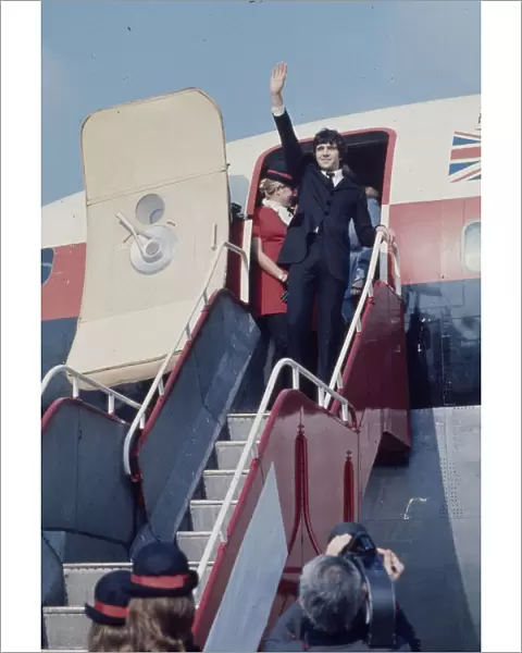 Jim MacLaine waves from the plane