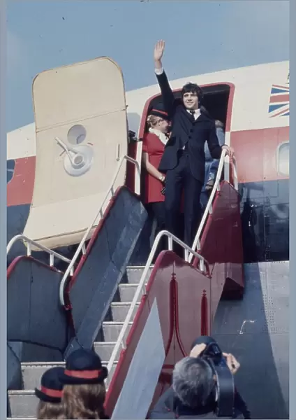 Jim MacLaine waves from the plane