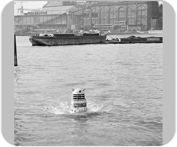 A Dalek emerges from the river Thames at the jetty near Battersea Church Road