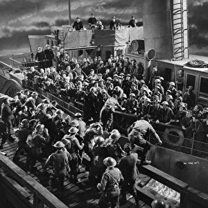 British soldiers board a ship at night