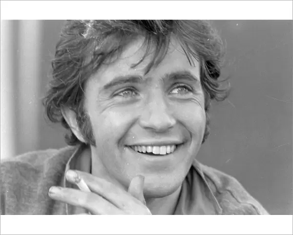 David Essex smiling and with cigarette in his hand