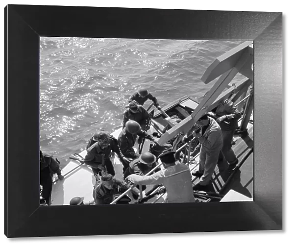 British soldiers board a Royal Navy ship