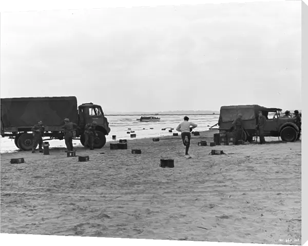 Two British Army trucks stranded on the beach