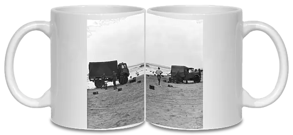 Two British Army trucks stranded on the beach