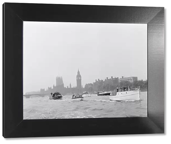 Small boats on the Thames with The Houses of Parliament in the background