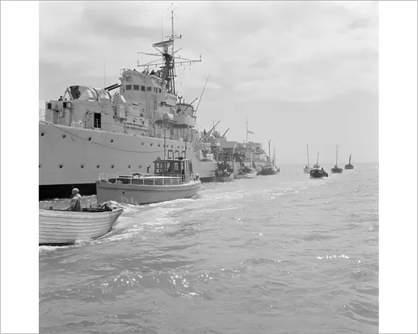 A Royal Navy ship and small boats