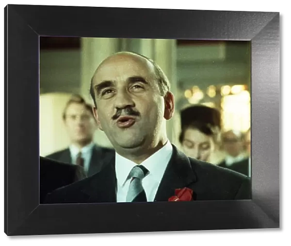 A close up of Warren Mitchell as Fred Midway