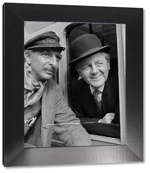 Naunton Wayne and Hugh Griffith smiling on set