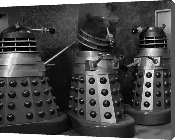 Two Daleks check the damage of a third one