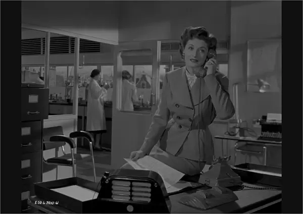 Helen Cherry on the phone in a scene from Young Wives Tale (1951)