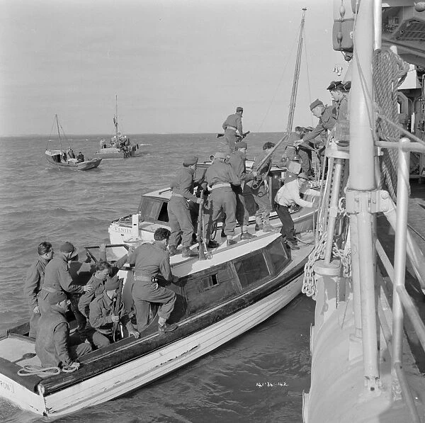 British soldiers board a Royal Navy ship