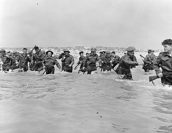 British soldiers run towards the small boats