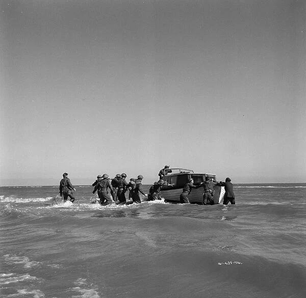 British soldiers try to board one of the small boats