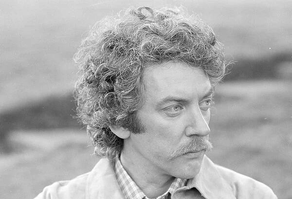 A close up of Donald Sutherland on the set of Don't Look Now (1973)