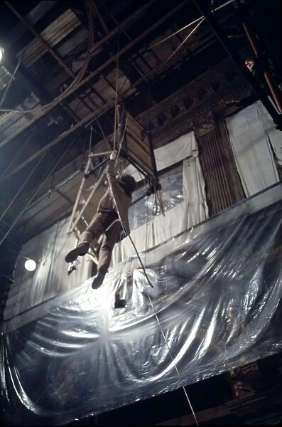 Donald Sutherland dangles from a rope in a scene from Don't Look Now (1973)