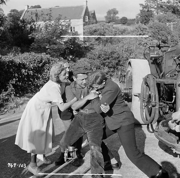 Hawkins in a fight. Sid James and Gabrielle Brune in a scene from The Titfield Thunderbolt