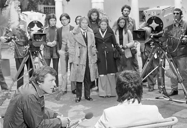 The interview. David Essex and Edd Byrnes in a scene from Stardust (1974)