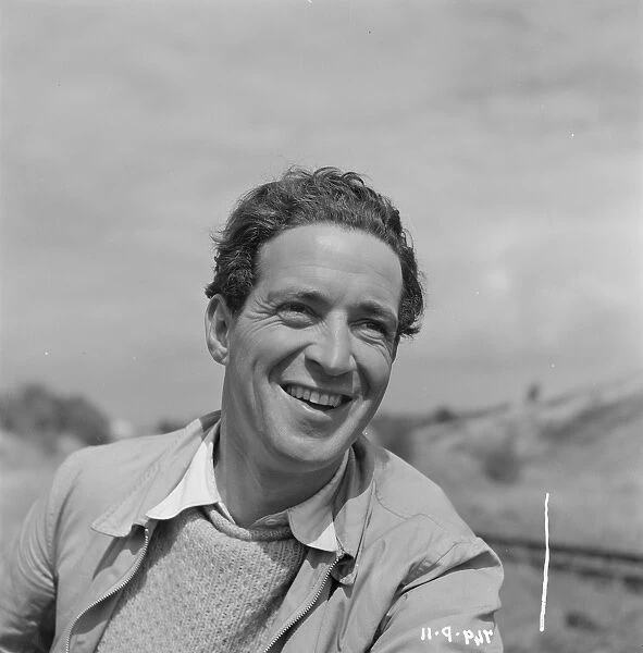 John Gregson. with a broad smile in a portrait for The Titfield Thunderbolt