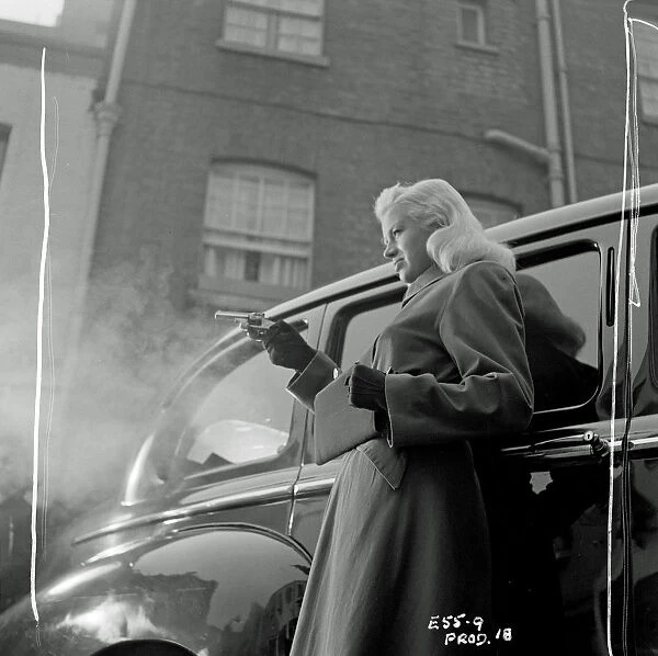 Mary Hilton shoots. Diana Dors in a scene from Yield to the Night