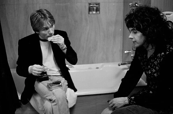 Mike rolls a cigarette as he talks to Jim