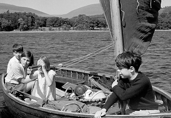 Sailing on the lake. The crew of Swallow in a scene from the film Swallows and Amazons