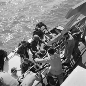 British soldiers board a Royal Navy ship