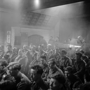 British soldiers watch a newsreel