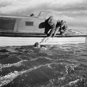 British soldiers in the water waiting to be rescued