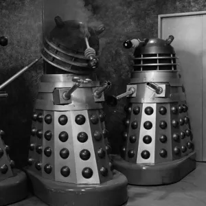 Two Daleks check the damage of a third one