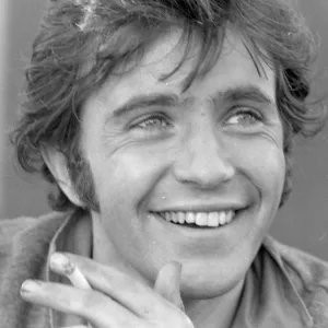 David Essex smiling and with cigarette in his hand