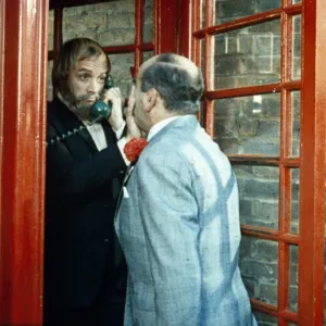 Fred Midway tries to enter a phone box