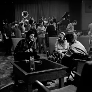 Jim Maclaine chatting up two girls at a party