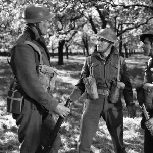 John Mills as Corporal Tubby Bins assesses the situation in the French countryside