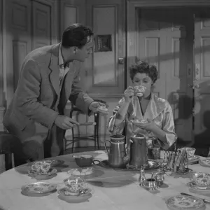 A production still image from Young Wives Tale (1951) set at the breakfast table