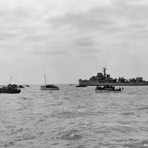 A Royal Navy ship and small boats A Royal Navy ship and small boats