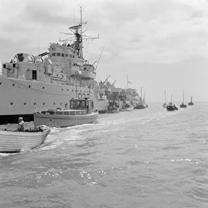 A Royal Navy ship and small boats