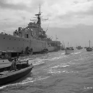 A Royal Navy ship and small boats A Royal Navy ship and small boats