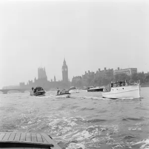 Small boats on the Thames with The Houses of Parliament in the background