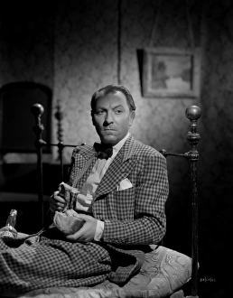 <b class=qtipBold><figcaption>Brighton Rock (1947)</figcaption></b><br>William Hartnell sits on a bed in a chequered suit in character as gangster Dallow.<br><em>© Copyright © Studiocanal Films Ltd</em> Brighton Rock (1947)