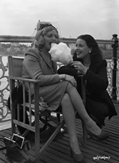 <b class=qtipBold><figcaption>Brighton Rock (1947) publicity</figcaption></b><br>Hermione Baddeley enjoys some cotton candy during a pause from filming with fellow actress Constance Smith.<br><em>© Copyright © Studiocanal Films Ltd</em> Brighton Rock (1947) publicity