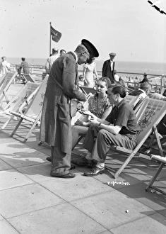 <b class=qtipBold><figcaption>Brighton Rock (1947) publicity</figcaption></b><br>Carol Marsh and Richard Attenborough pay their dues to rent deck chairs on the Brighton promenade in this promotional shoot for the film.<br><em>© Copyright © Studiocanal Films Ltd</em> Brighton Rock (1947) publicity
