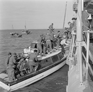 British soldiers board a Royal Navy ship
