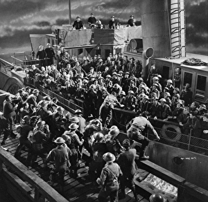 British soldiers board a ship at night