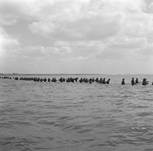 British soldiers try to board one of the small boats