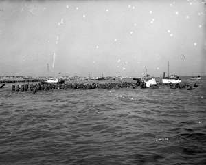 British soldiers try to board one of the small boats during a German bombardment