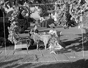 Negs Collection: Edith, played by Valerie Hobson and Louis, played by Dennis Price take tea in the garden