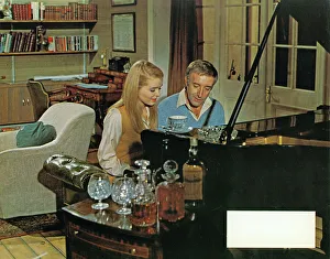 <b class=qtipBold><figcaption>Hoffman (1970)</figcaption></b><br>Sinead Cusack as Janet Smith and Peter Sellers as Benjamin Hoffman at the piano in a lobby card used for the UK theatrical release of the film in 1970.<br><em>© Copyright Studiocanal Films Ltd</em> Hoffman (1970)