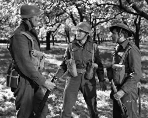 Dunkirk Collection: John Mills as Corporal Tubby Bins assesses the situation in the French countryside