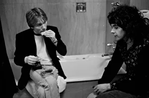 Mike rolls a cigarette as he talks to Jim