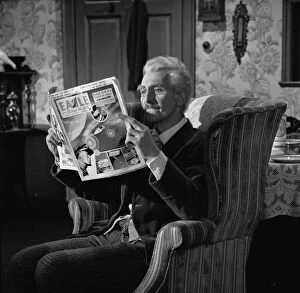 Images Dated 19th January 2013: Peter Cushing as Dr Who reads The Eagle